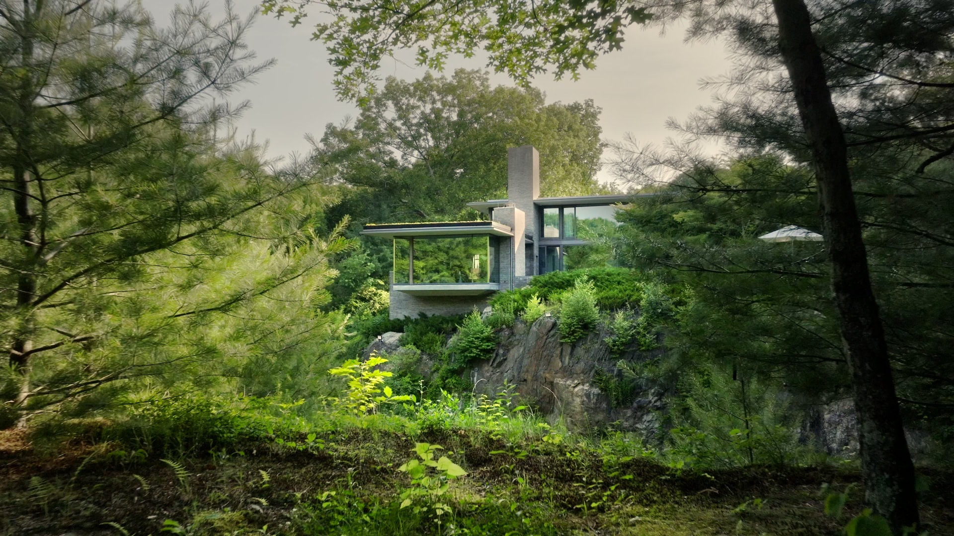 Bedford Quarry — Glass-walled house on a rocky ledge surrounded by dense trees