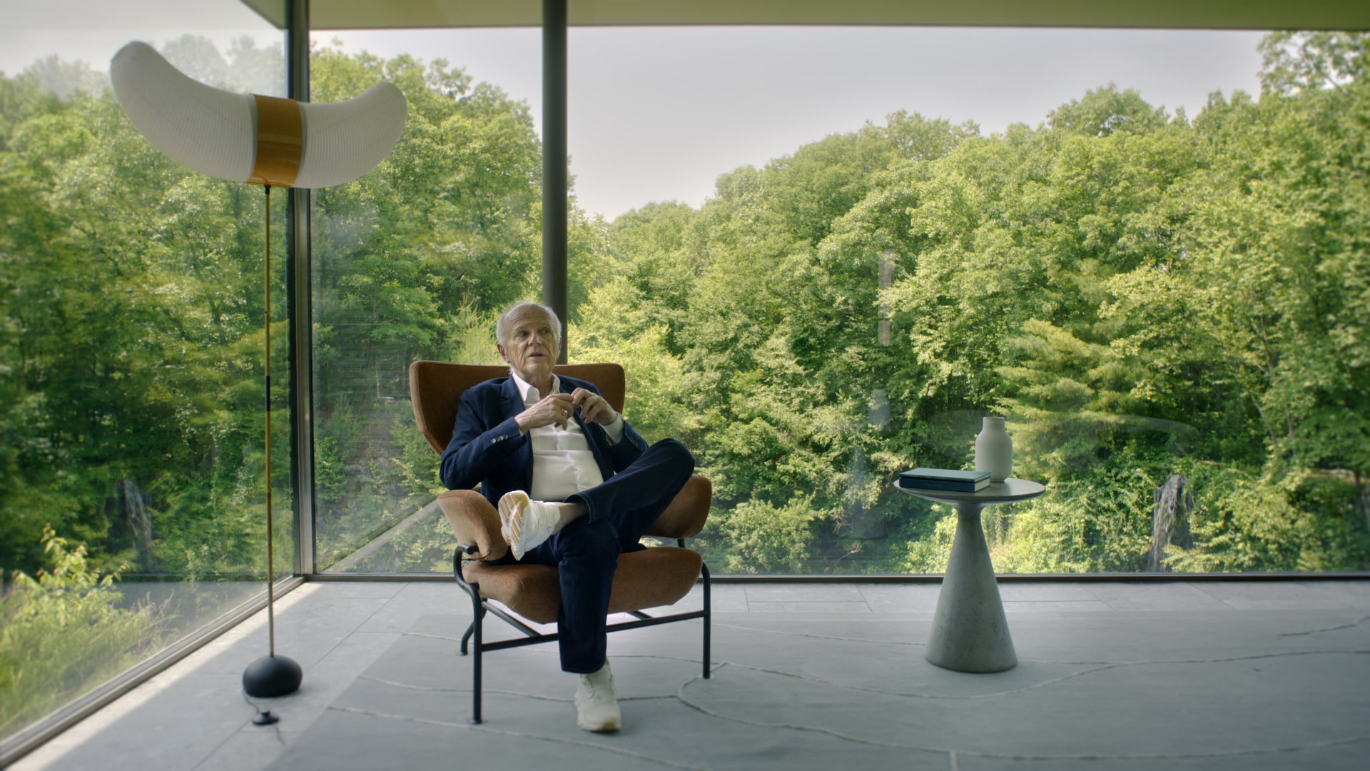 Bedford Quarry — Man seated in a leather lounge chair in the glass-walled room