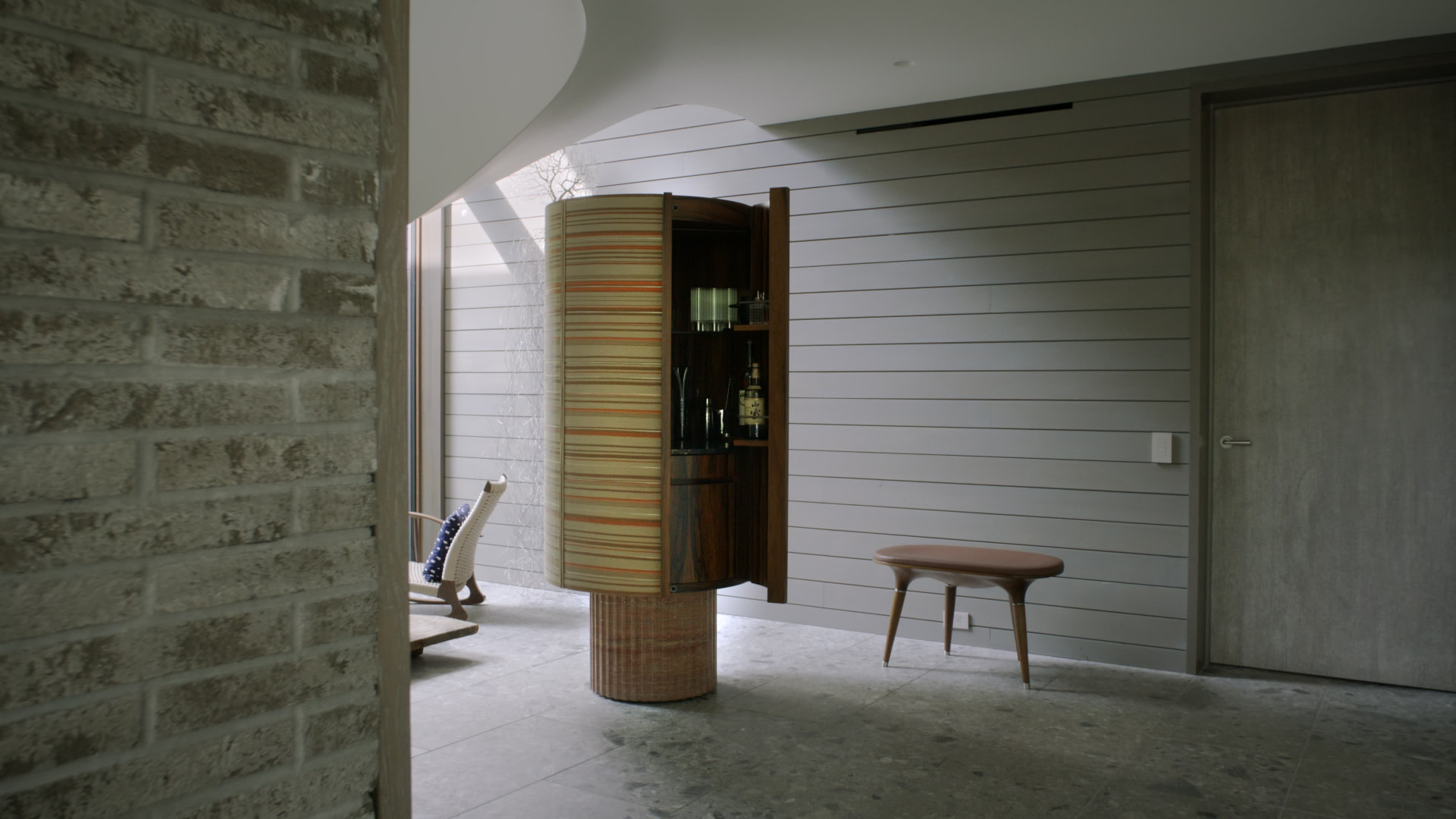 Bedford Quarry — Cylindrical timber bar cabinet with a striped orange interior