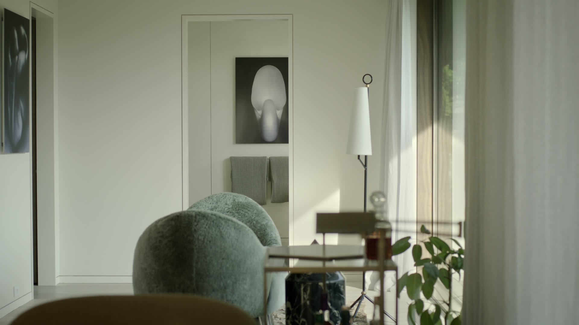 Bedford Quarry — Doorway view into a white room with modern furniture and artwork
