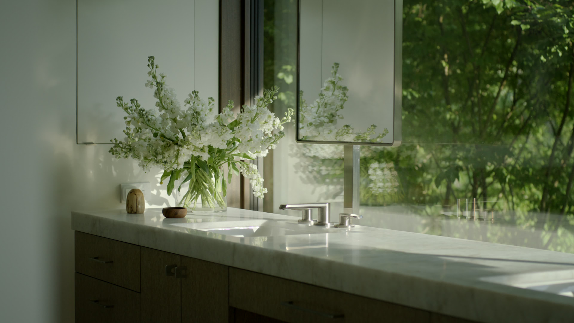 Bedford Quarry — Marble bathroom vanity with a modern tapware and white flowers