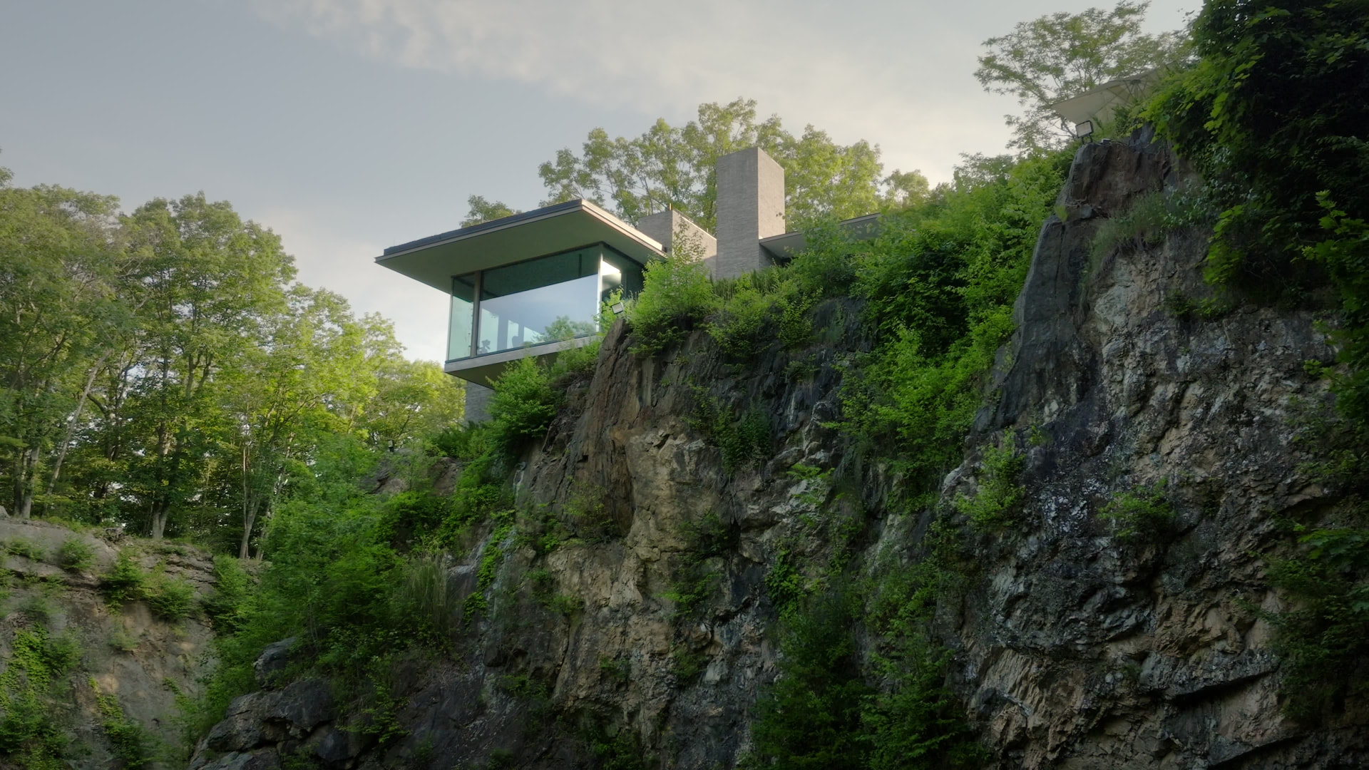 Bedford Quarry — Low-angle view of the glass house over the rocky cliff edge