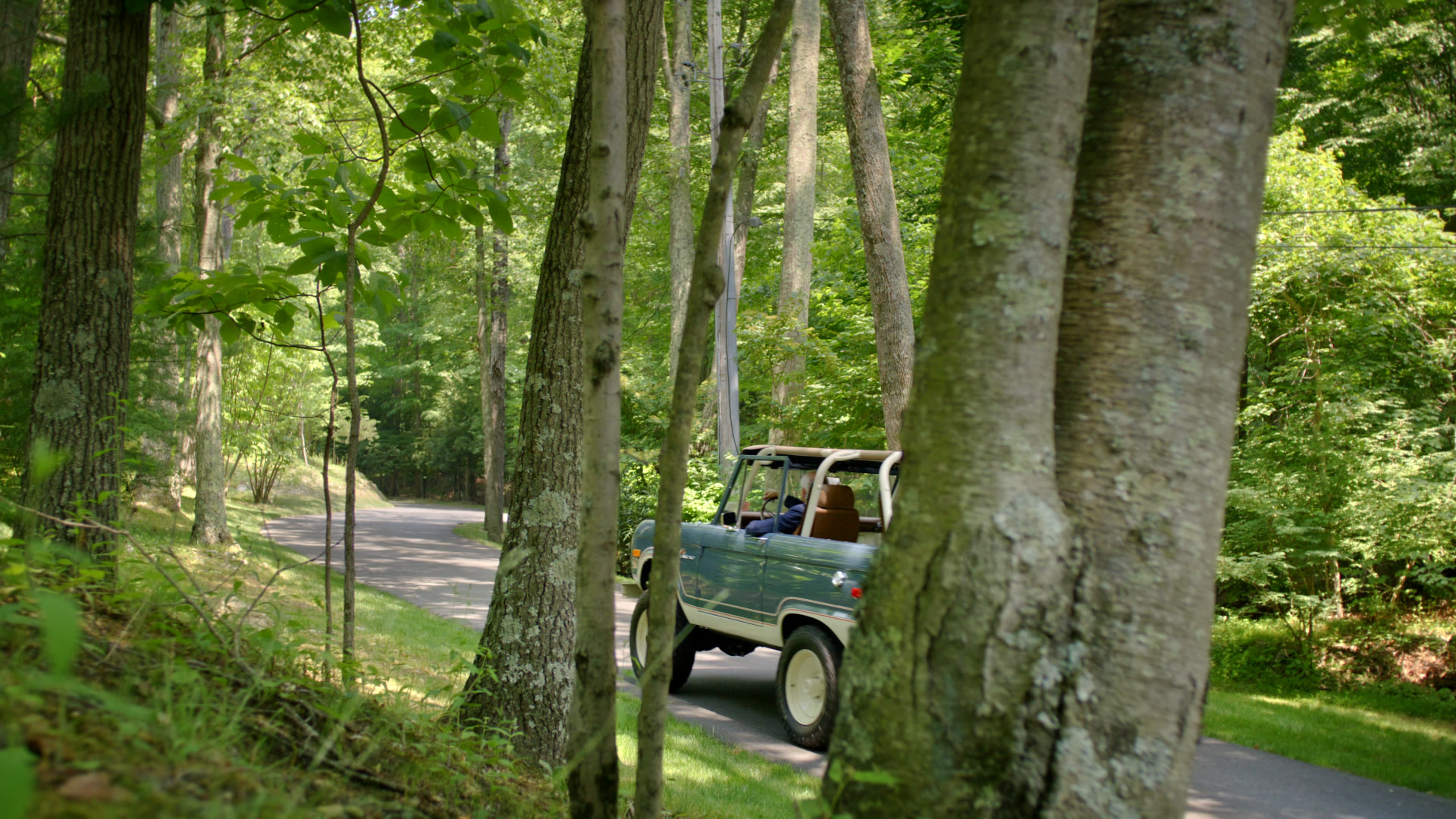 Bedford Quarry — Vintage blue SUV on a winding road through woodland