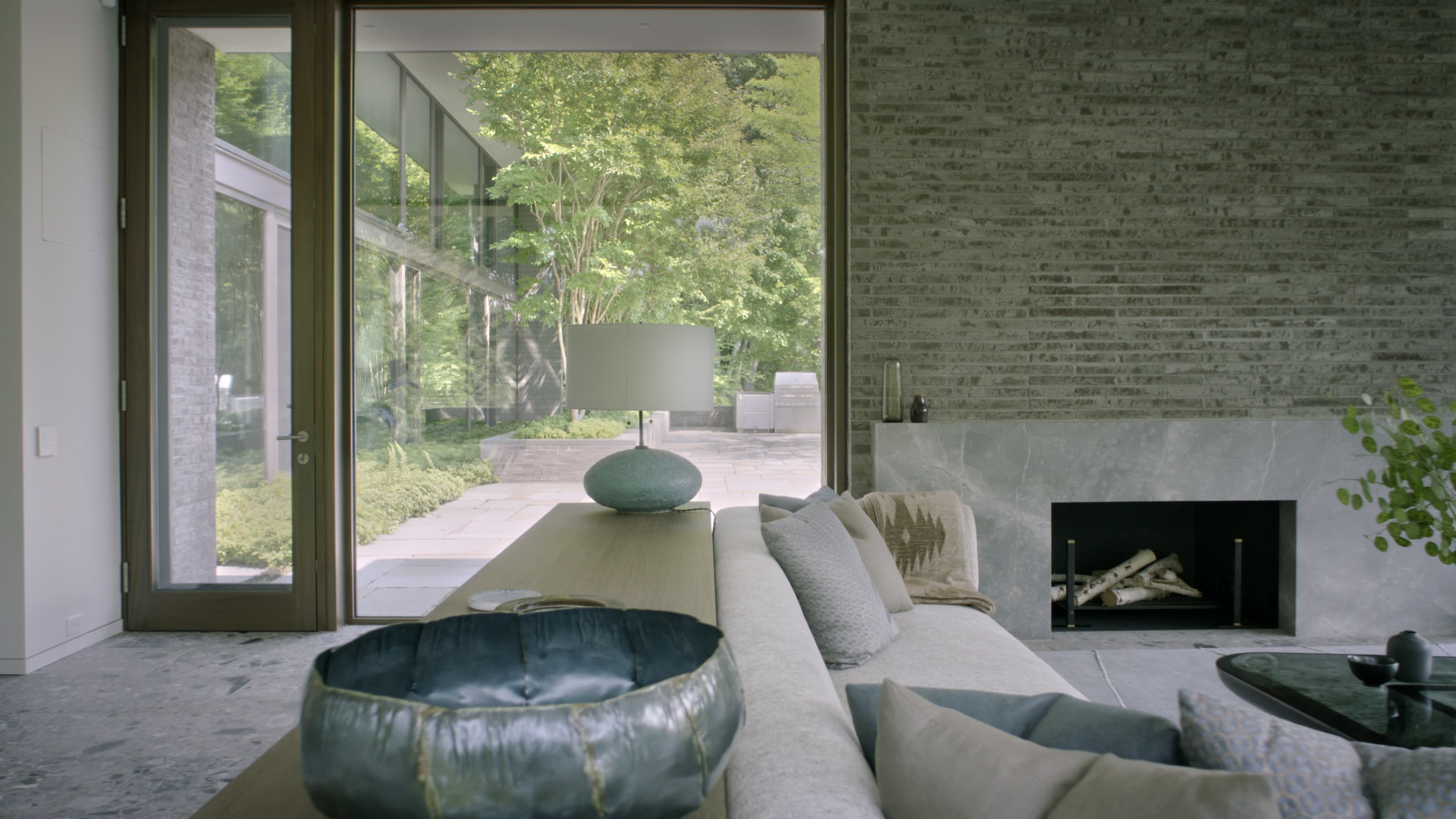 Bedford Quarry — View past a sofa and marble fireplace to the outdoor patio
