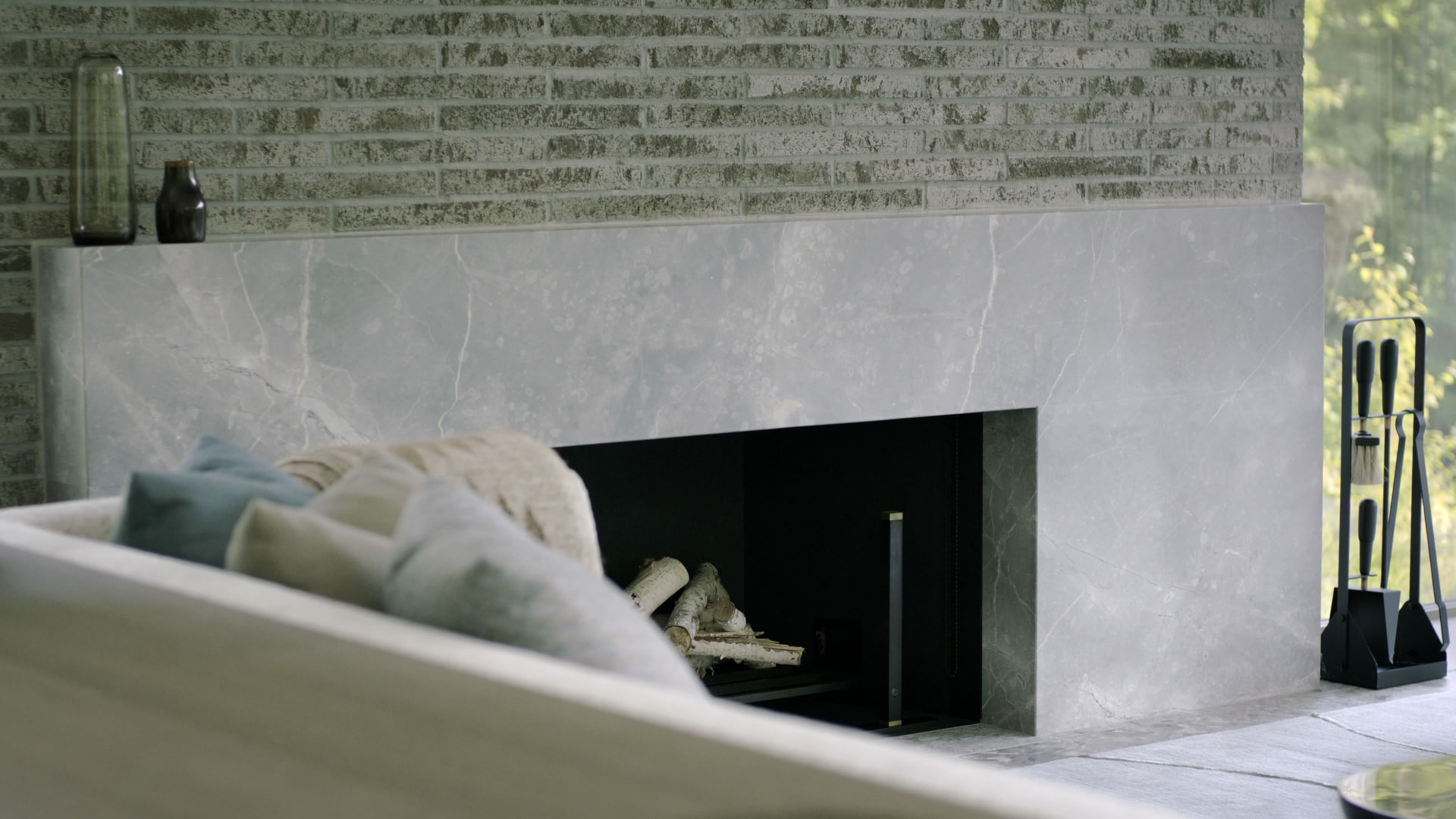 Bedford Quarry — Minimalist grey marble fireplace with stacked logs
